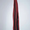 Red and Black bullhide leather swivel flogger with long flat falls and finger loop handle on white background