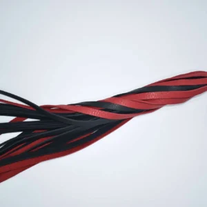 red and Black bullhide leather swivel flogger with long flat falls and finger loop handle on white background